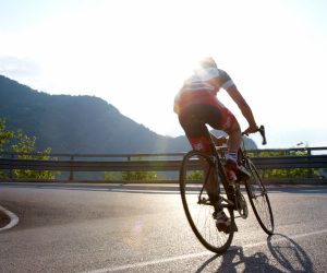 Man riding road bike uphill